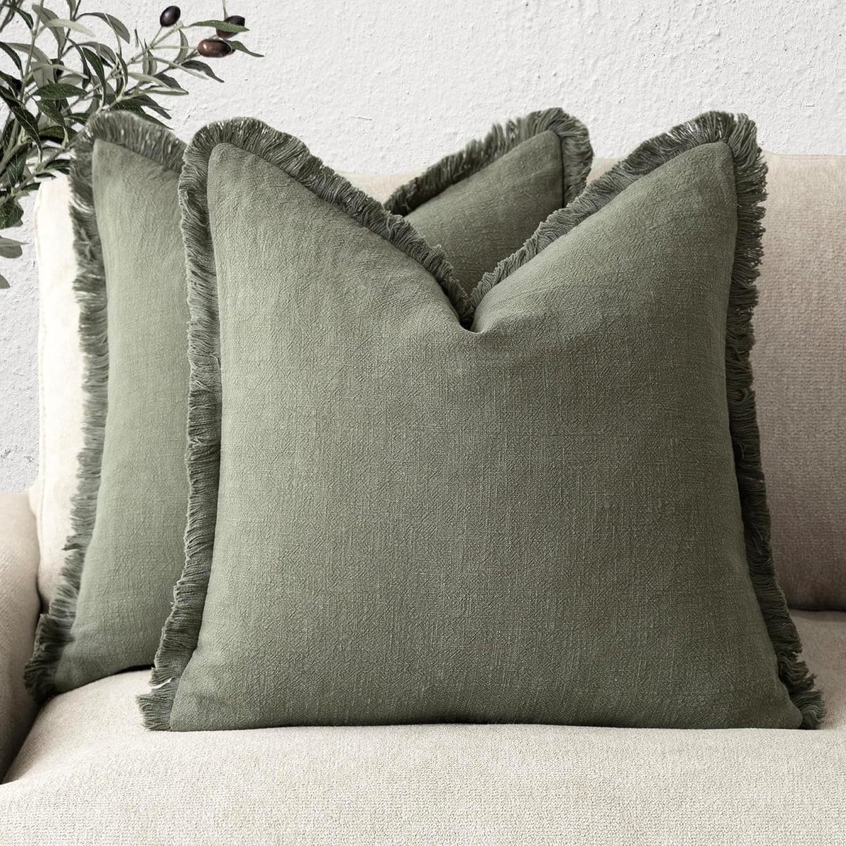 beige couch with pillows